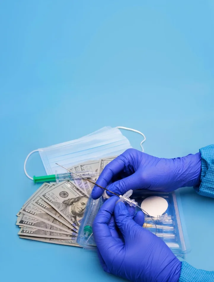 Gloved hands with cash and a syringe
