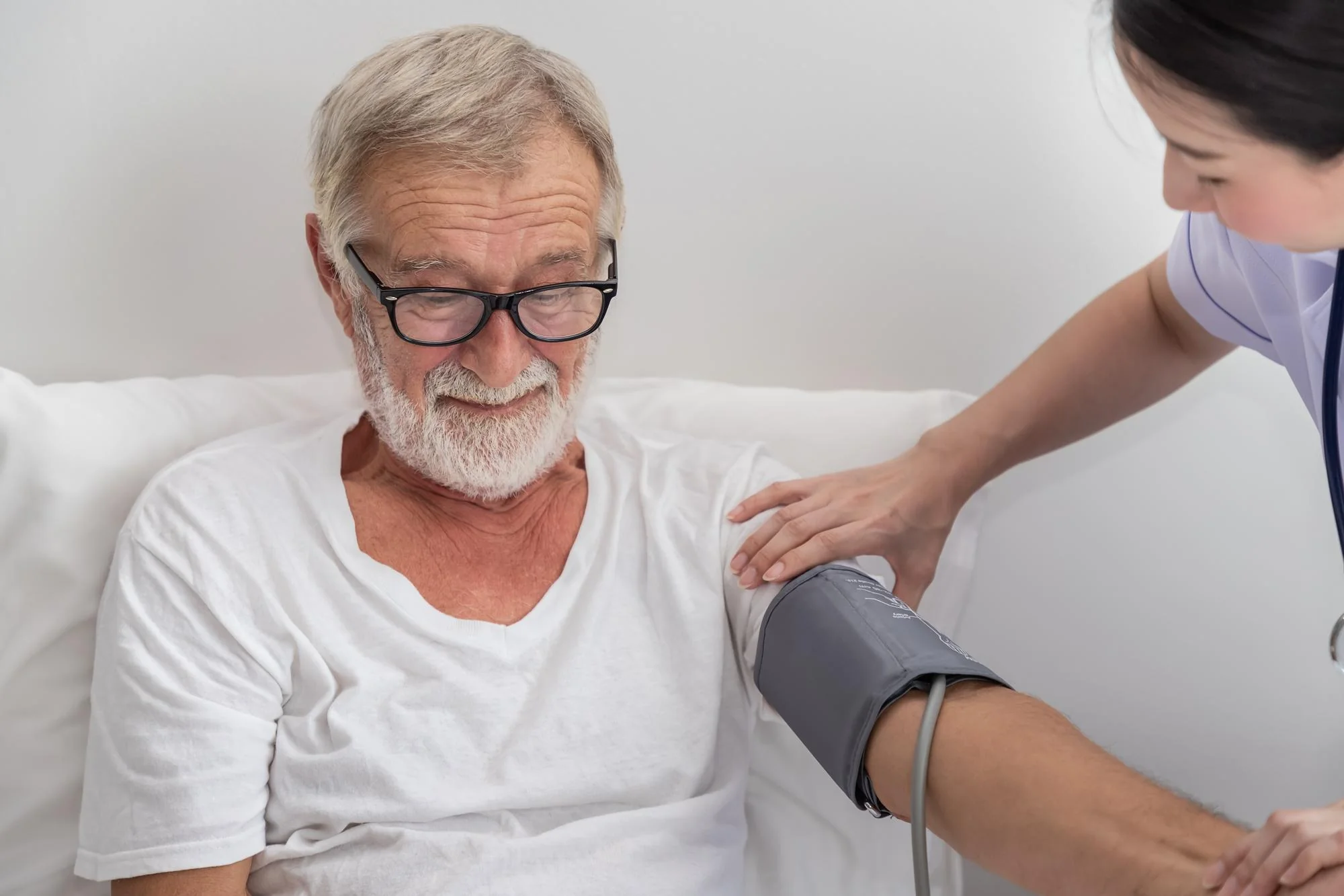 A clinician taking a blood pressure reading with a cuff