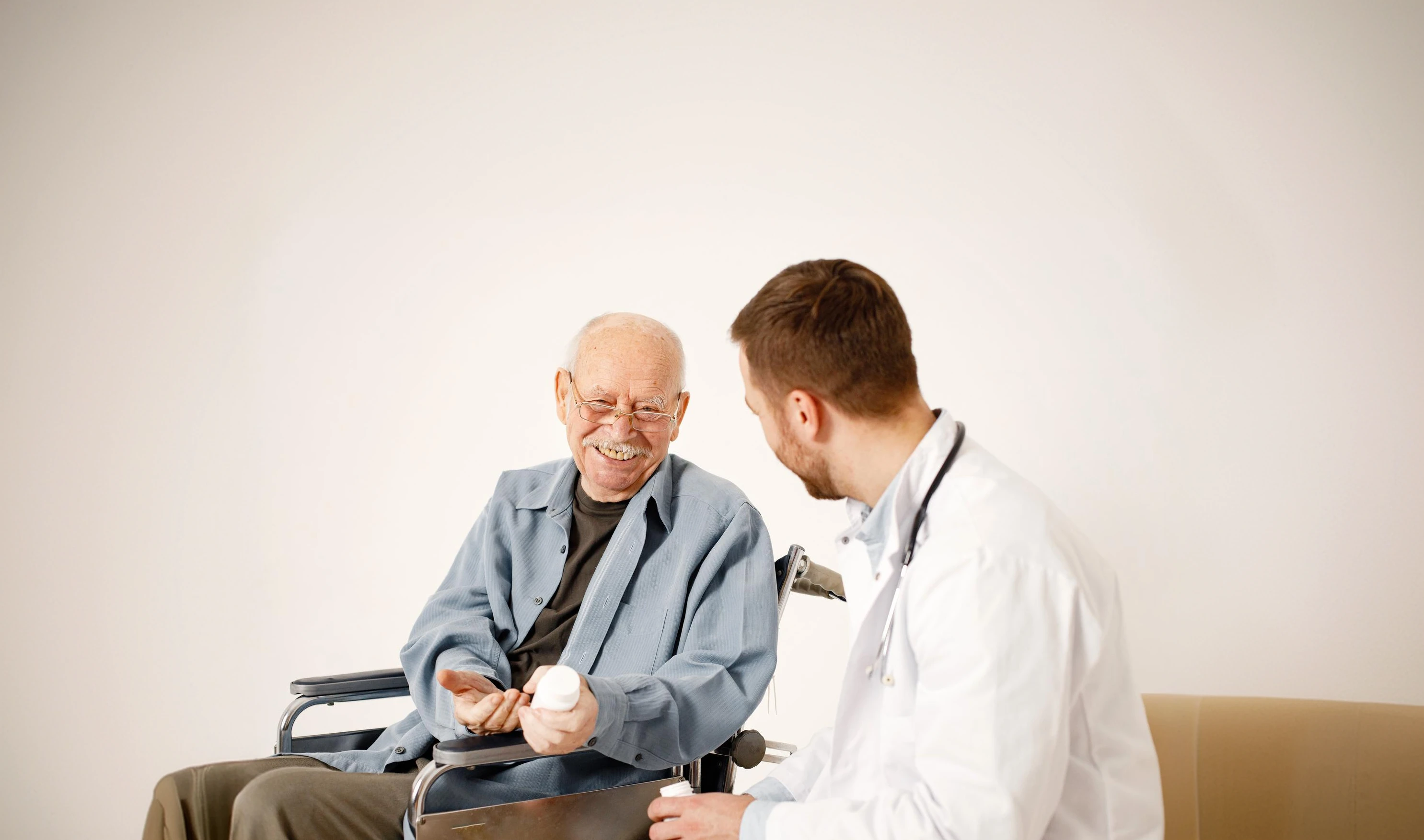 A clinician talking with an older patient in a wheelchair