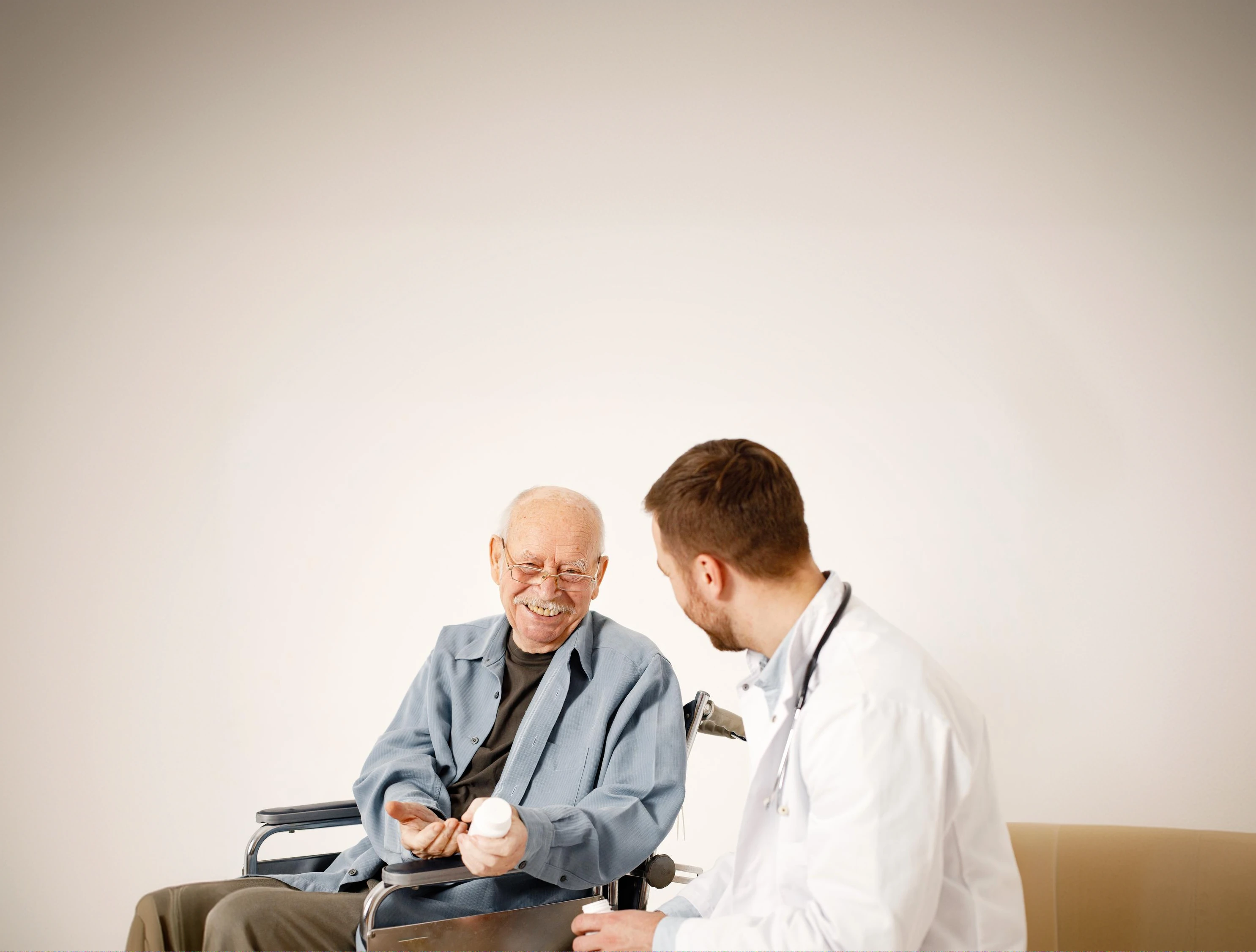 A clinician talking with an older patient in a wheelchair